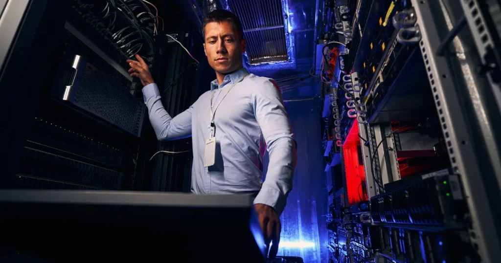man standing in a server room deploying a custom hedge fund application built by Nu-Age