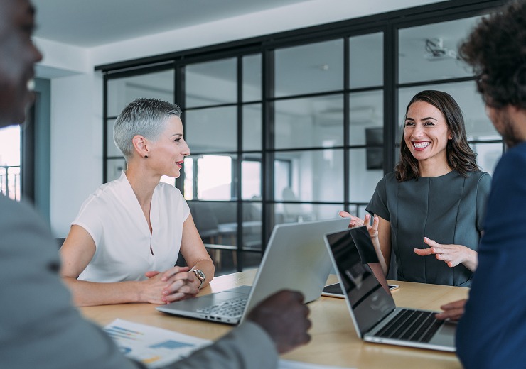 Professional team discussing advancements in Managed IT Services in modern fintech office environment